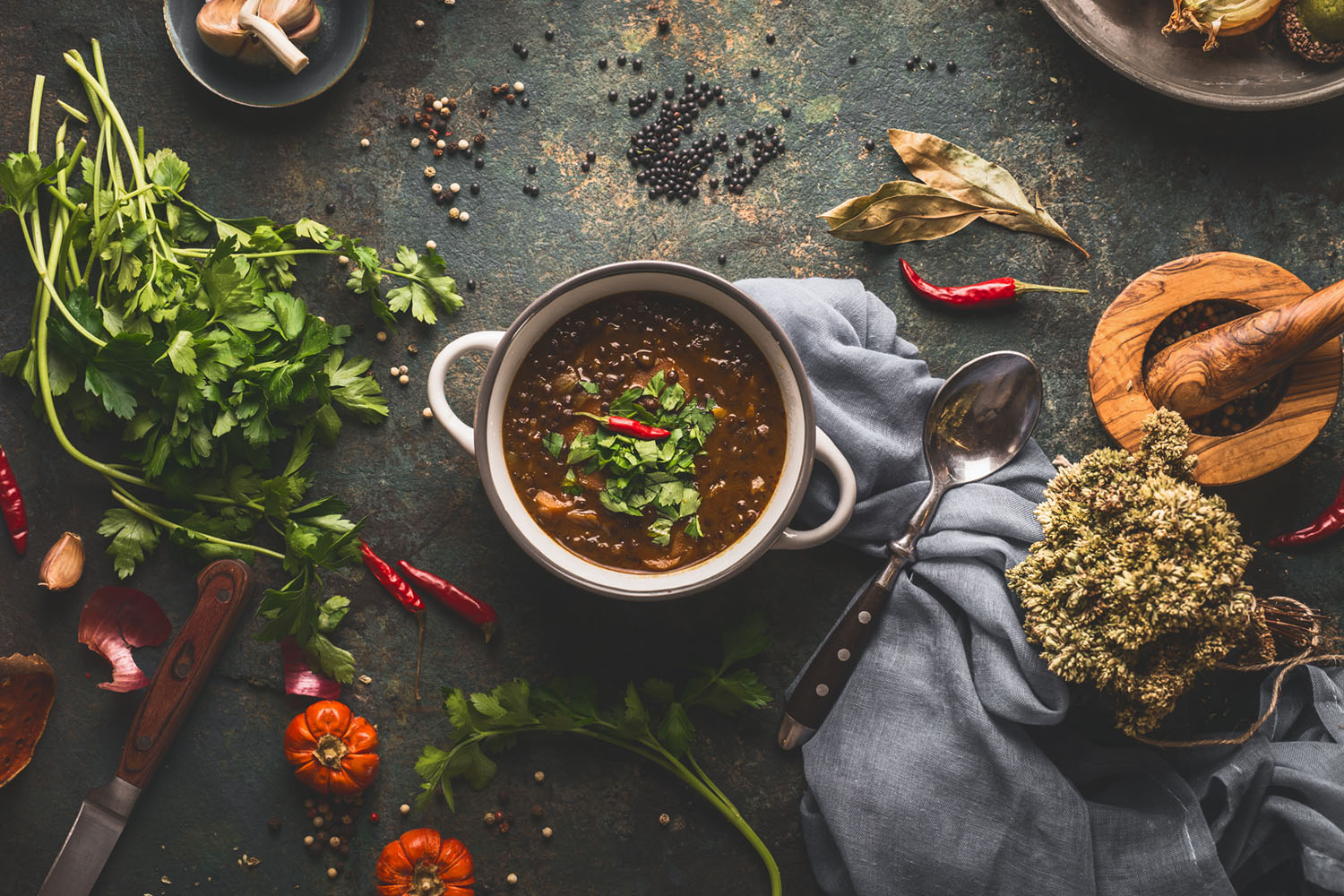 Vegan food. Bowl with lentil soup on rustic kitchen table backgr